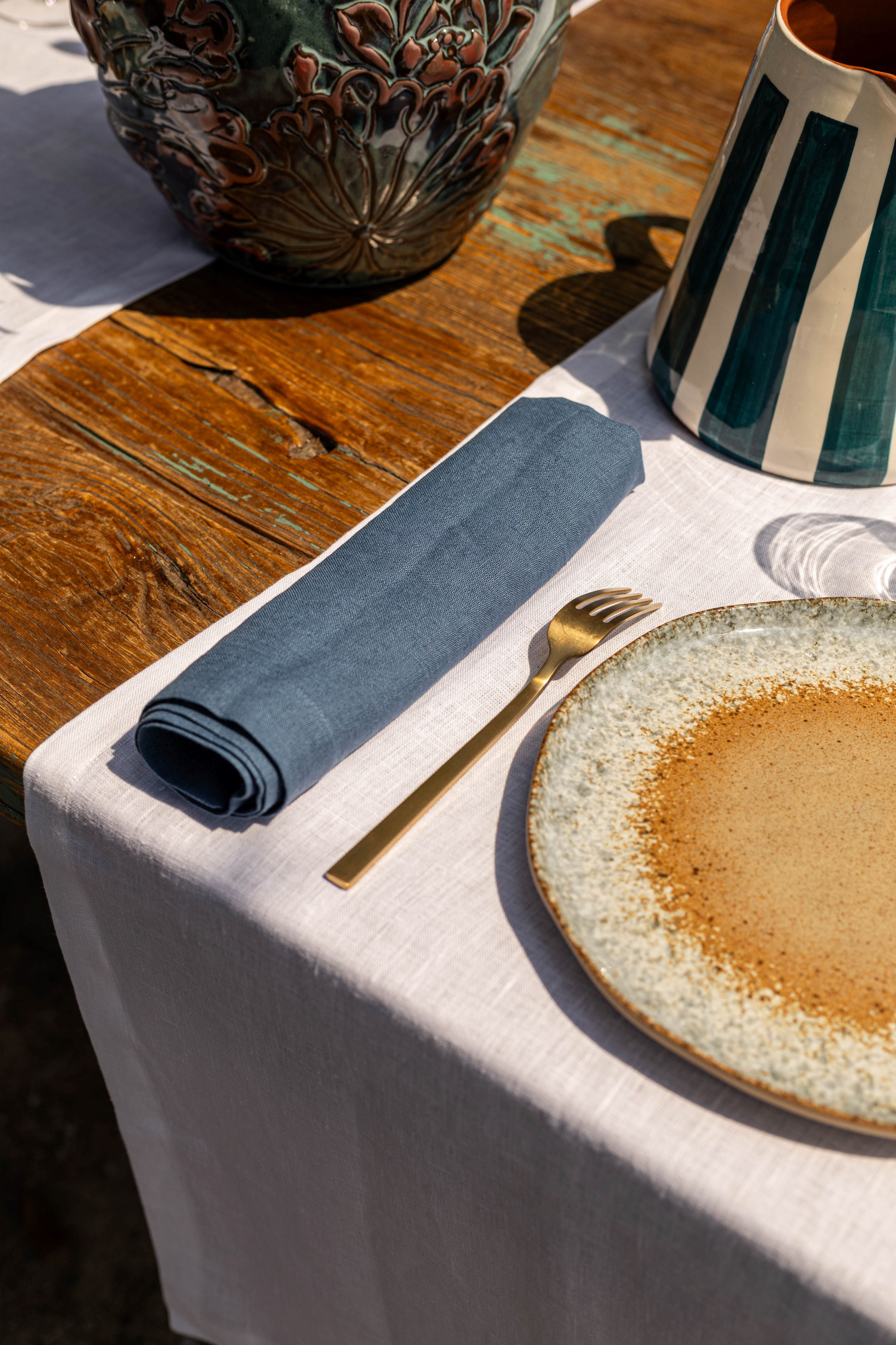 white linen table runner and blue linen napkins