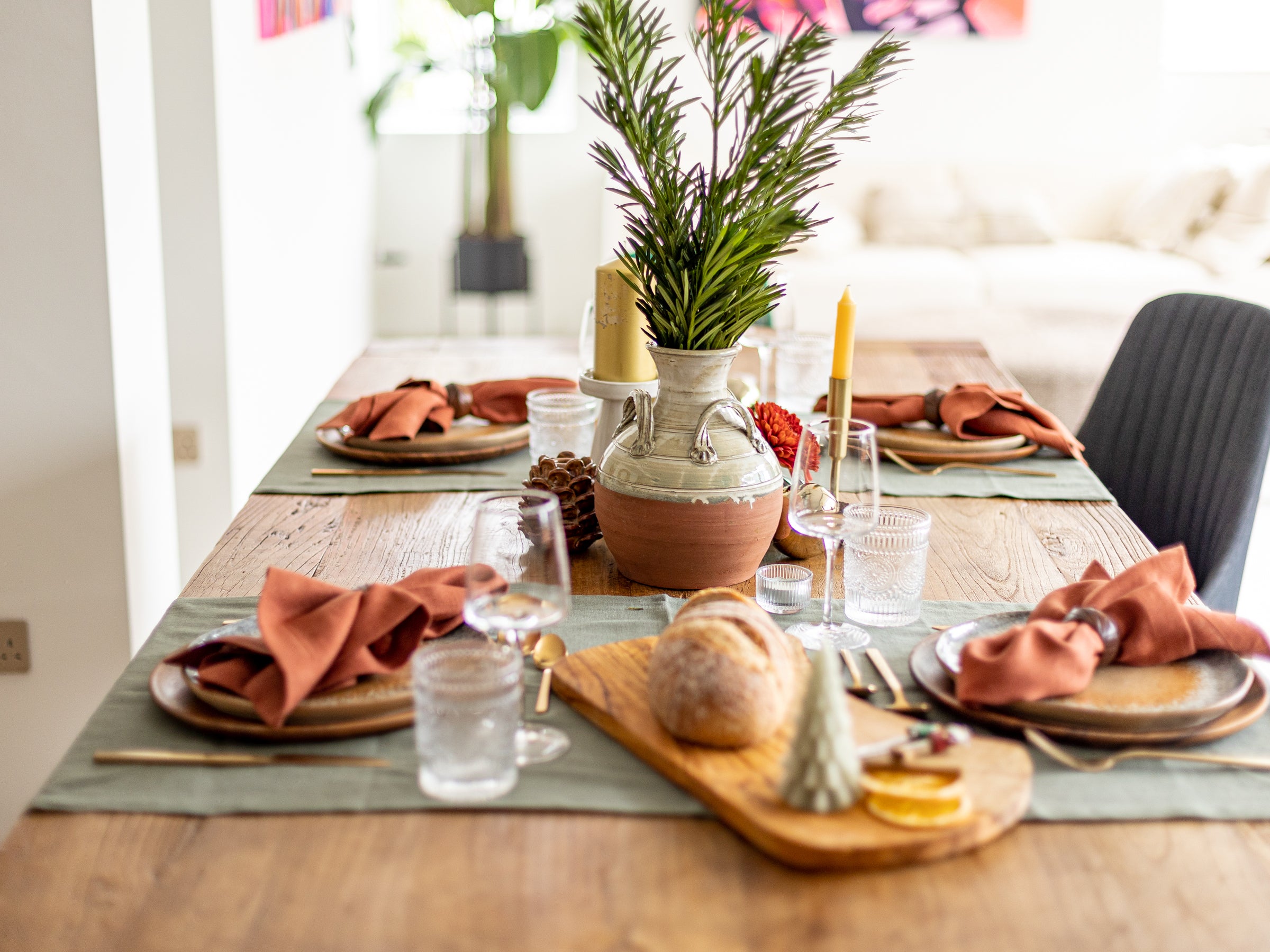 Terracotta linen table runner with green olive napkins 